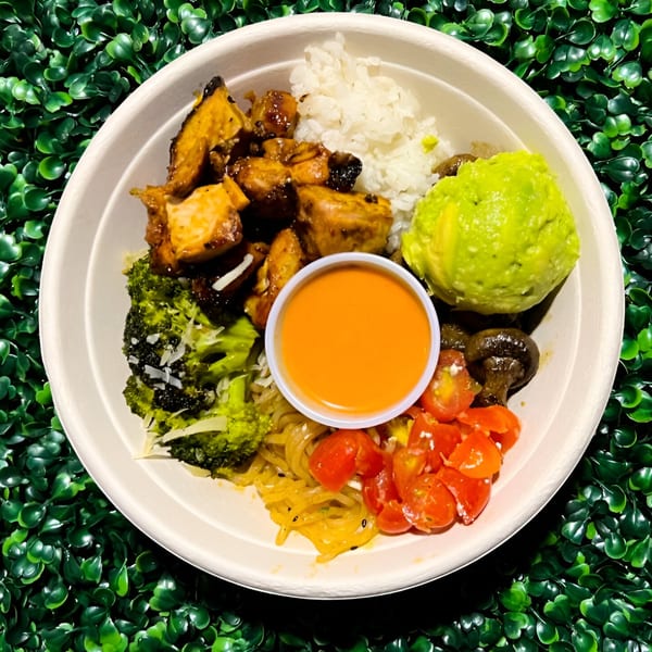Fork 'N' Bowl's healthy bowl with chicken, rice, avocado, broccoli, tomatoes, mushrooms, and sauce.