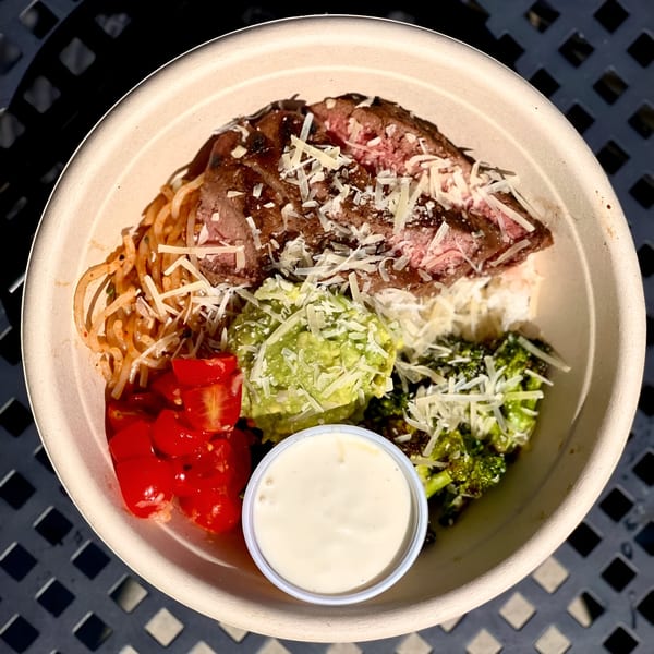 Fork 'N' Bowl's healthy steak bowl with noodles, tomatoes, guacamole, broccoli, and dressing.