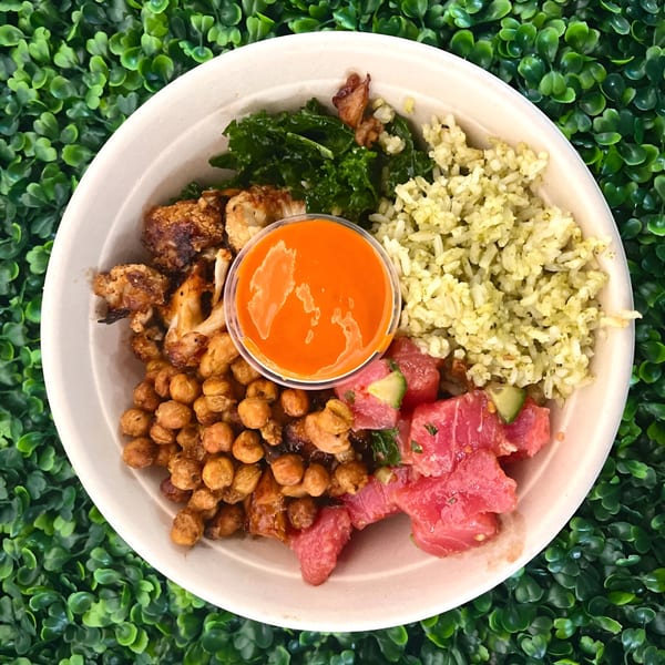 A Fork 'N' Bowl with tuna poke, roasted chickpeas, cauliflower, kale, and green rice.
